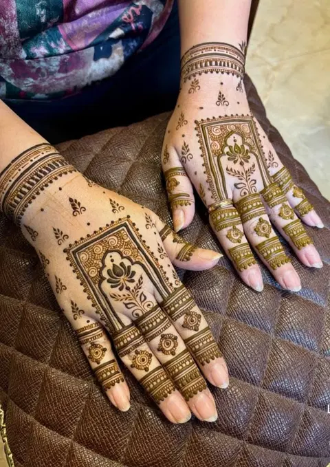 bridal minimal deity arm mehndi design