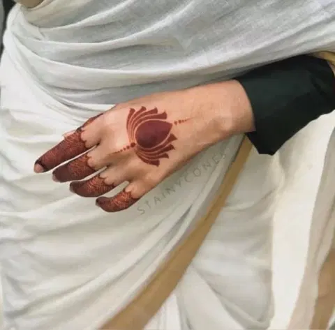 aesthetic minimal lotus back hand mehndi design