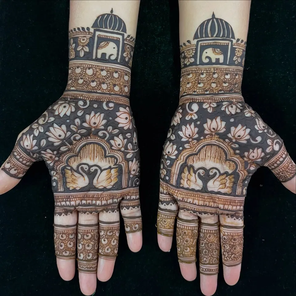 Stylish Back Hand Mehndi Design with Figures and Lotus for Sawan