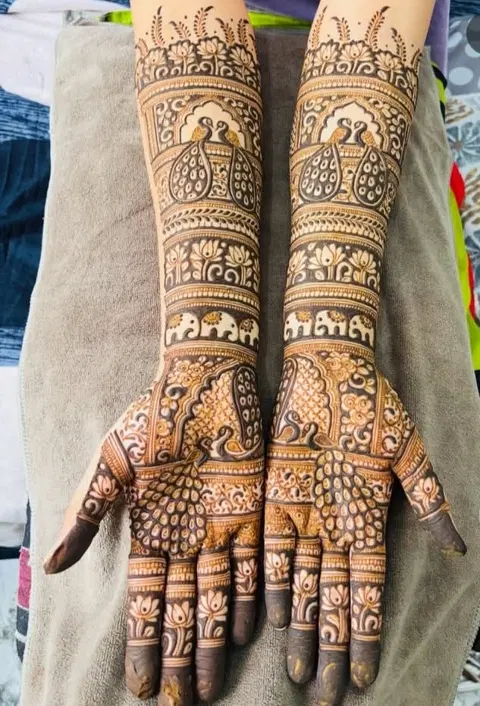 bridal indian figure back hand mehndi design