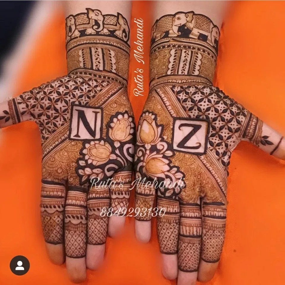 Bridal Back Hand Mehndi Design with Deity, Figures and Lotus