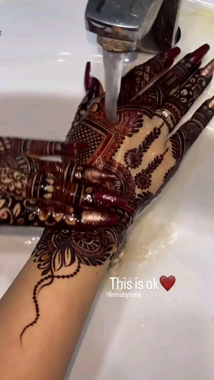 Aesthetic Bridal Finger Mehndi Design with Gol Tikki, Deity and Flowers for Engagement