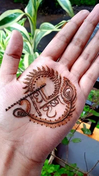 Simple Back Hand Mehndi Design with Deity and Peacock