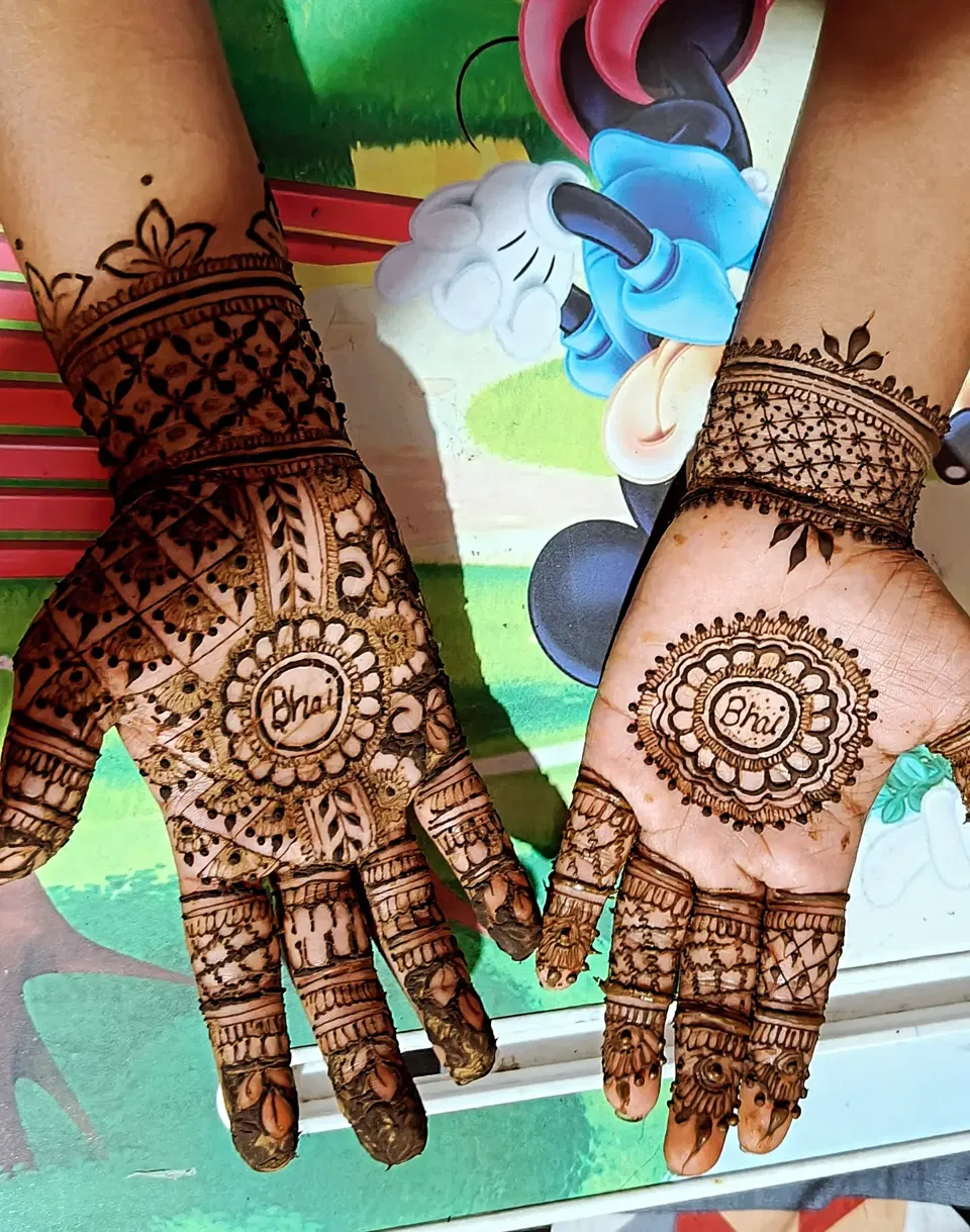 Aesthetic Front Hand Mehndi Design with Gol Tikki and Figures for Raksha Bandhan