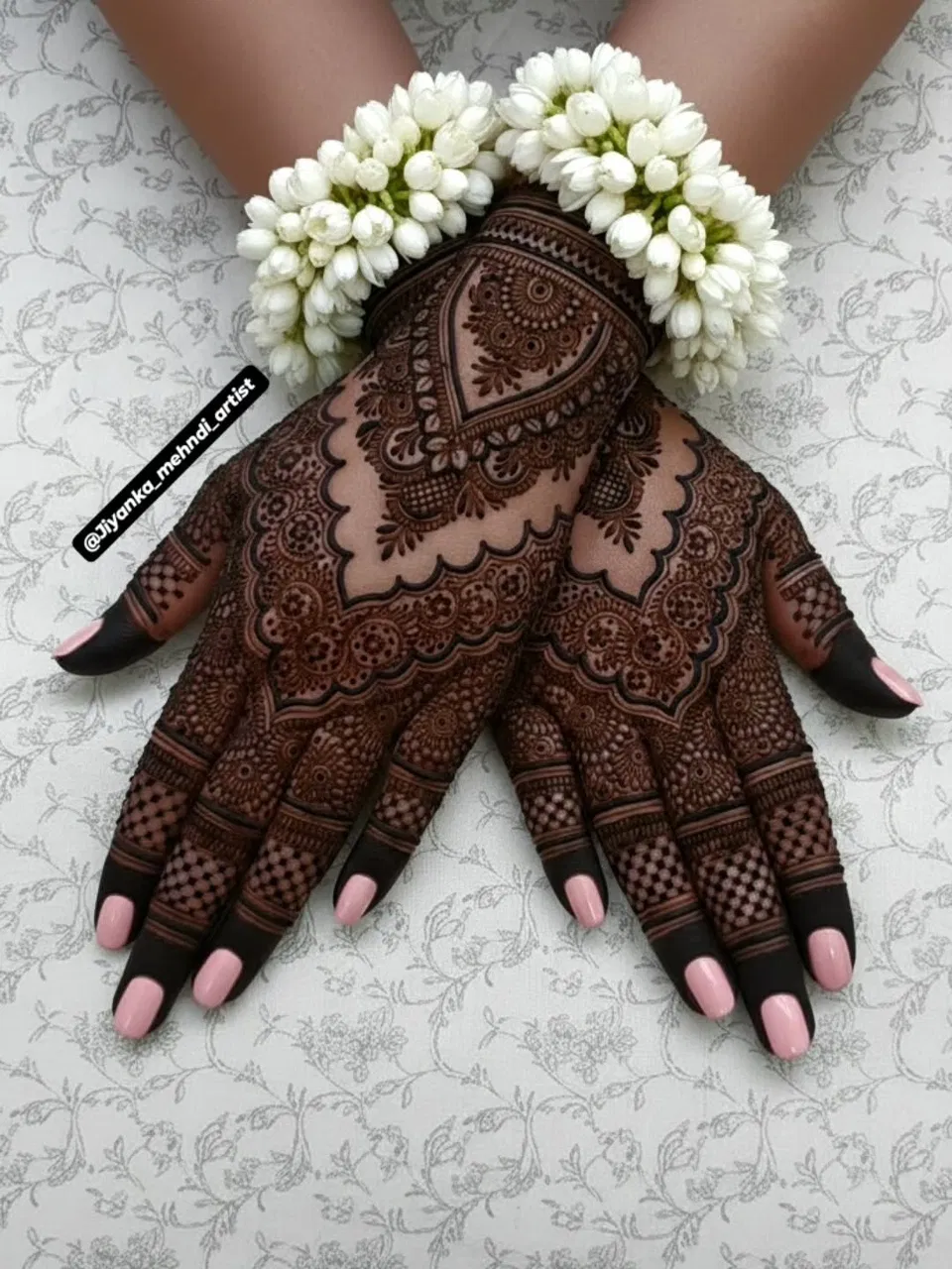 Aesthetic Bridal Back Hand Mehndi Design with Figures, Flowers and Jaal