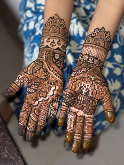 bridal indian figure back hand mehndi design