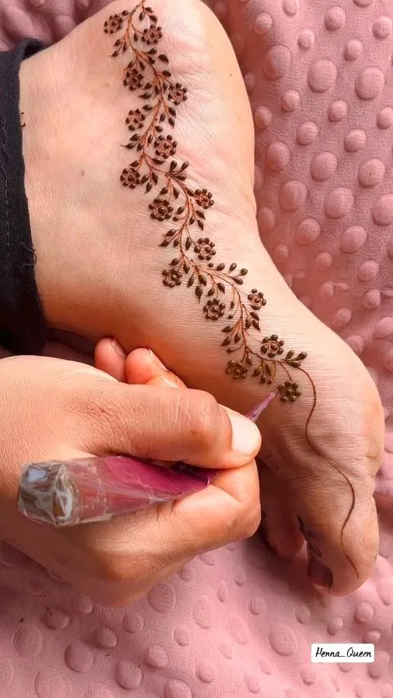 Minimal Pakistani Foot Mehndi Design with Bel and Flowers