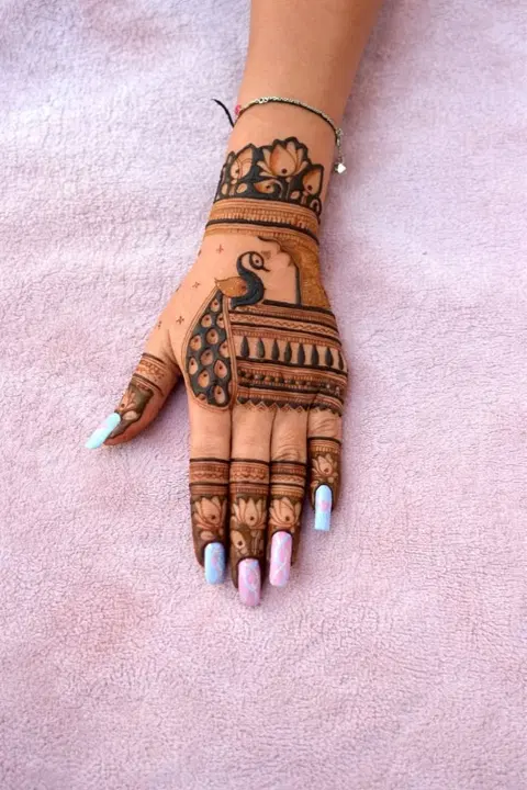 aesthetic indian peacock back hand mehndi design